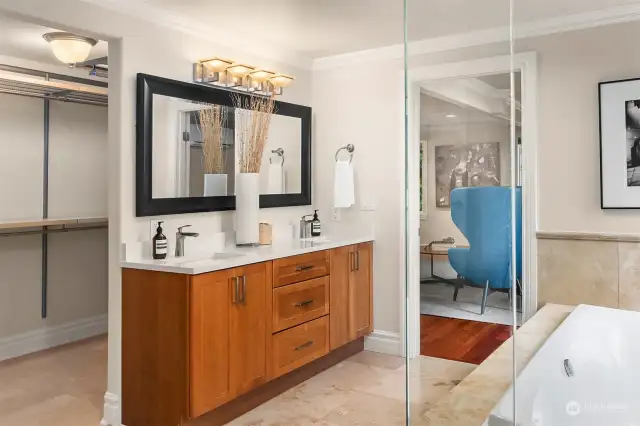 Primary ensuite 5-piece bath showcases new cabinetry, quartz countertops, shower and soaking tub.