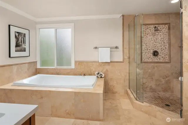 Large and elegant soaking tub, perfect for relaxing. Tiled shower is oversized as well.