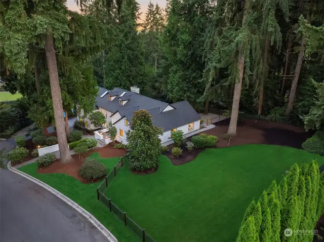 Beautiful, mature landscaping boasts a large, fully fenced yard, a second fully fenced dog run, and updated sport court for basketball/pickleball.