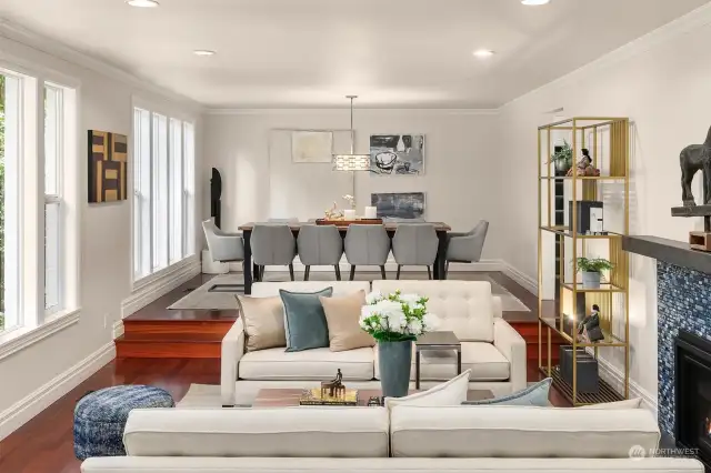 Living room features gas fireplace with custom blue tile backsplash. Oversized windows flood the room with natural light.