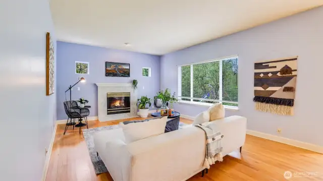 Warm and inviting living room centered around a cozy fireplace- a great spot to relax and unwind