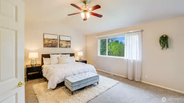 This primary bedroom is bathed in soft, natural light, creating a warm and inviting retreat