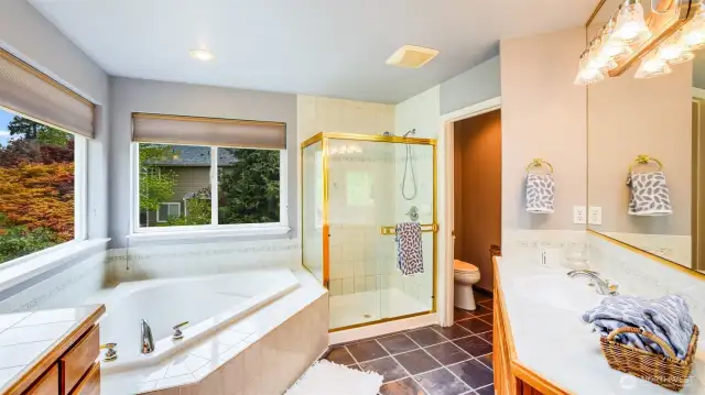 This en suite features an enclosed toilet area, providing added privacy within the main bathroom