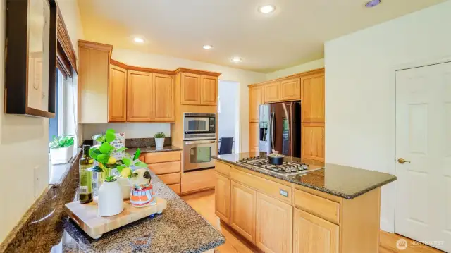 This kitchen offers abundant storage with a walk in pantry and extensive cabinetry.