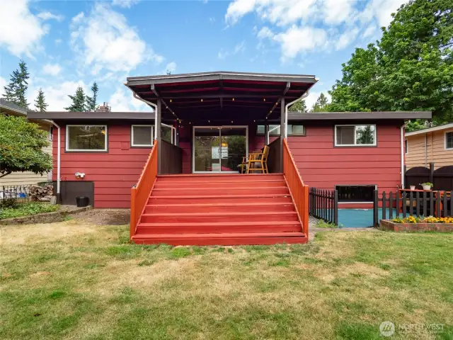 Covered deck connects house to backyard