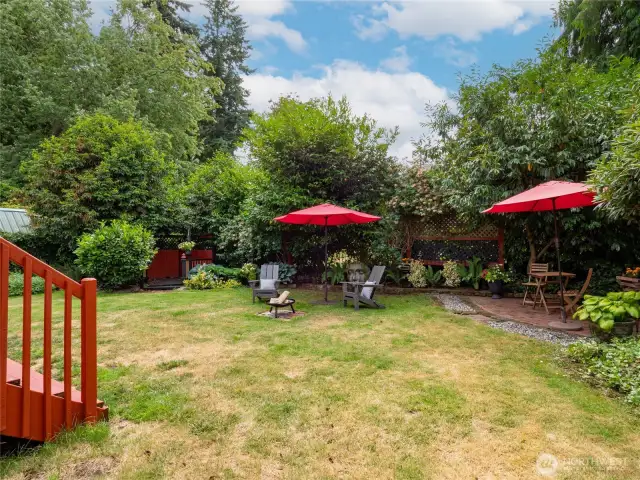 Established plantings surround the open lawn area. Space to host a big party.