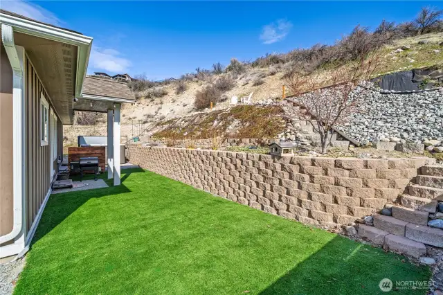 The back space has trendy faux grass for easy care.