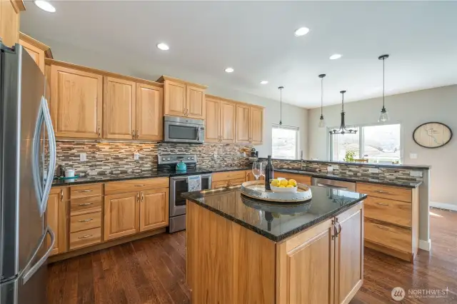 Sleek granite counters and glass tile enhance this fabulous kitchen