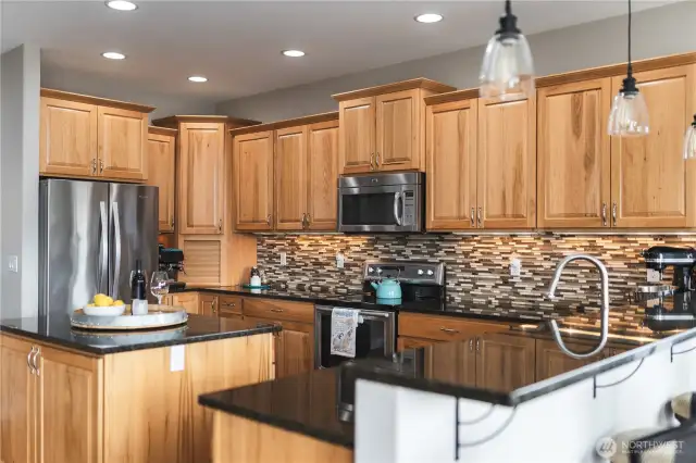 Stainless steel appliances, a breakfast bar plus a large walk-in pantry.