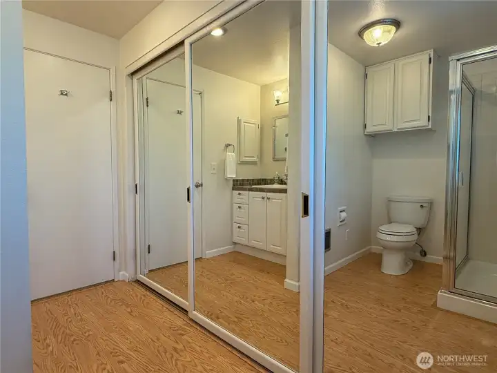 Primary bathroom has a wonderful wall of closets and storage.