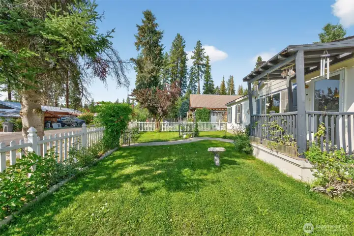 Fully fenced yard with roses and various flowers