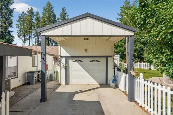 Garage with covered car port and shop