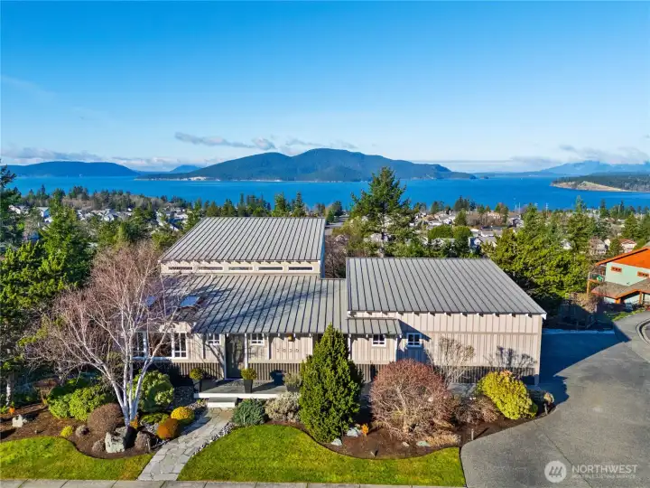Perched to capture breathtaking water and island views, this beautifully maintained home pairs modern style with lush landscaping for an unforgettable Northwest living experience.