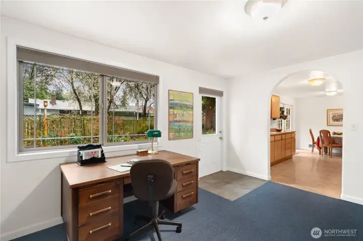 Family room has mostly been used as an office space. Large window and door to the back yard.