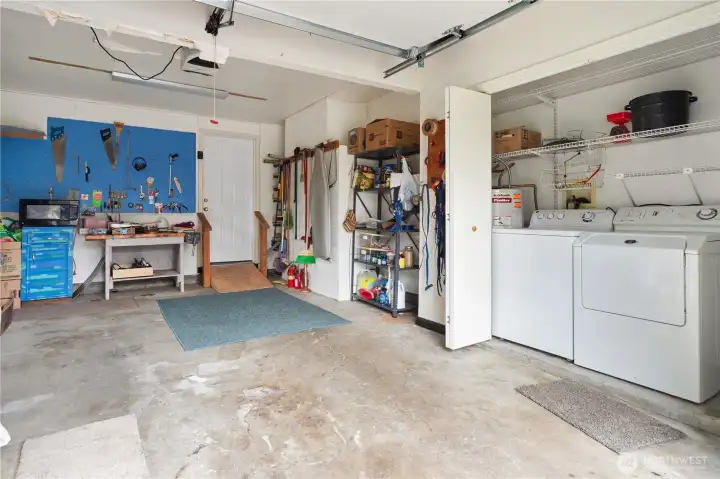 Garage is a large attached single garage with a workbench and washer/dryer.