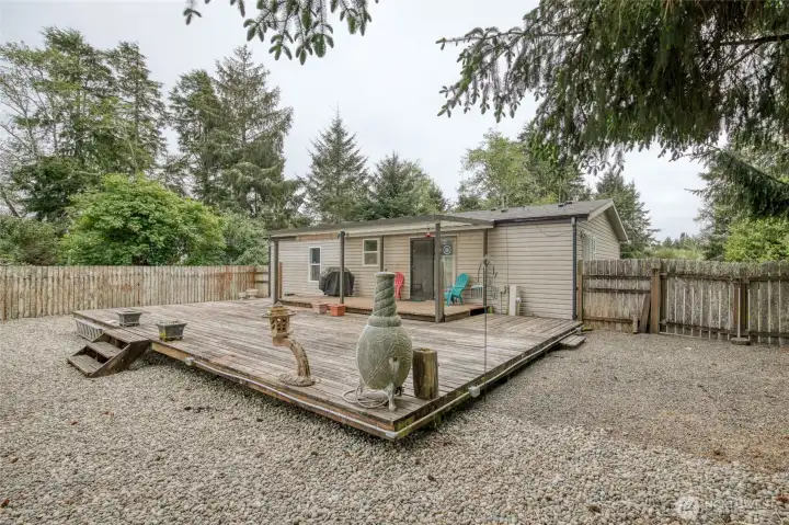 Fully fenced backyard is low maintenance and has a large deck for entertaining