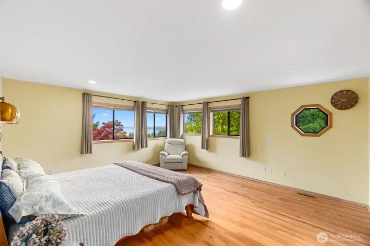 Primary bedroom is large and has beautiful views.