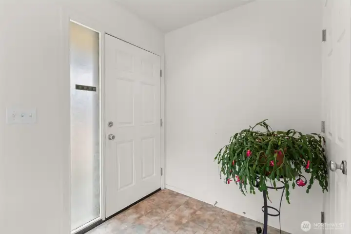 The entry with coat closet. The entry with coat closet.