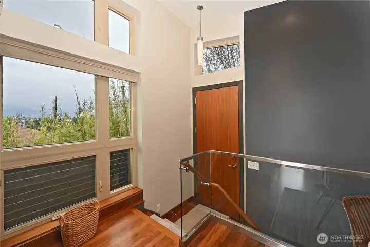 Lovely entry with walnut floors, custom floor to ceiling windows. Lovely entry with walnut floors, custom floor to ceiling windows.