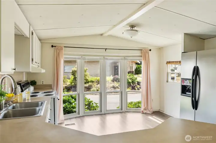 Bay windows with newer window treatments - nice spot to put a little dining nook.