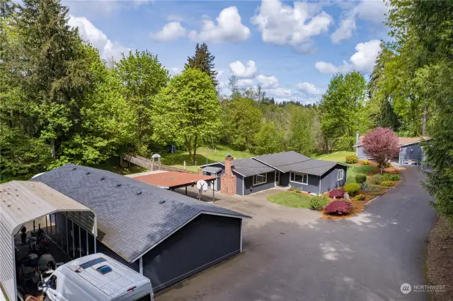 Plenty of parking, two shop/garages, massive driveway with RV cover
