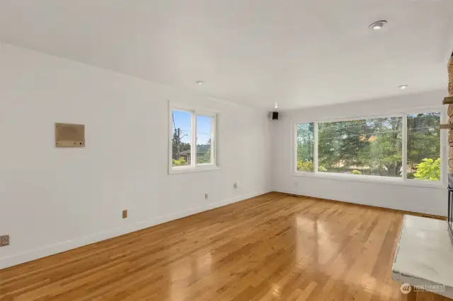 Large family room with triple pane windows.