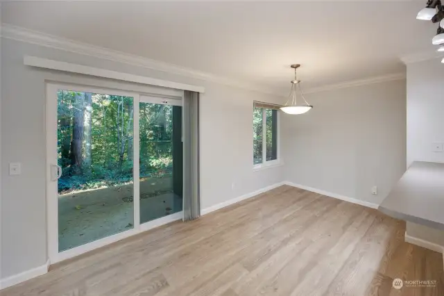 Dining area with slider to private patio with outdoor storage.