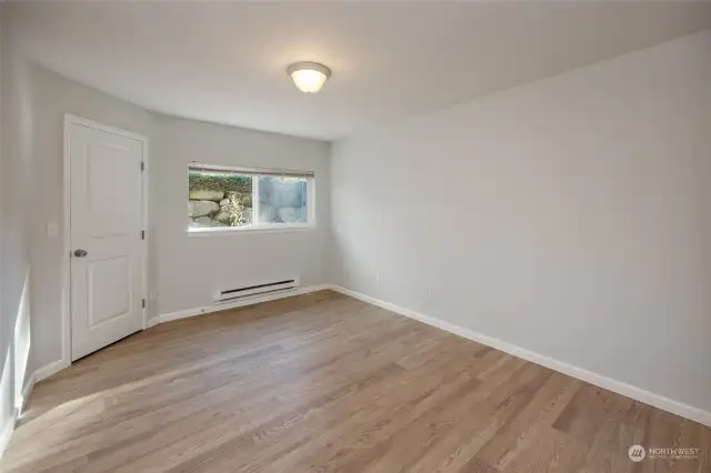 Living room with wood burning fireplace.