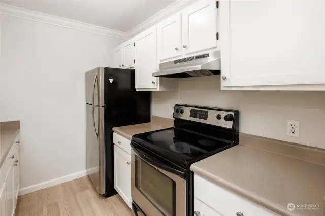 Updated kitchen with stainless appliances and new flooring and paint.