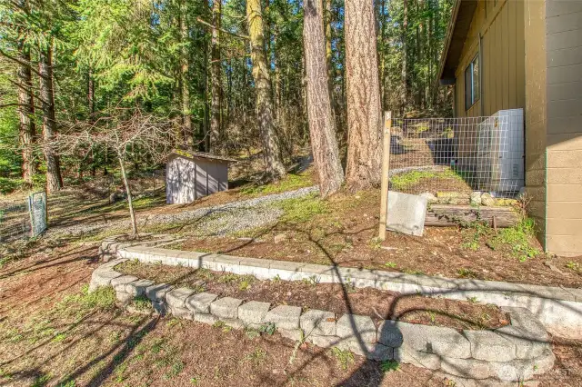 Fenced side yard for pets or gardening.