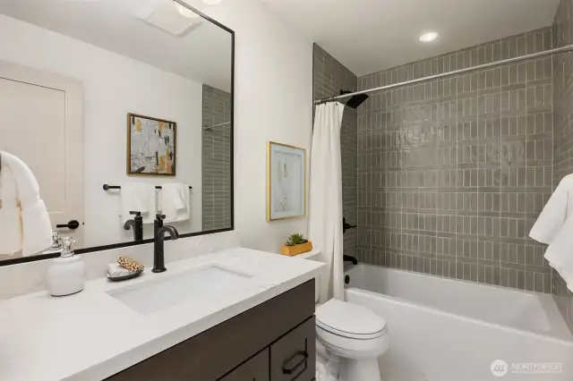 Gorgeous tiles line this deep shower/tub on the upper floor.