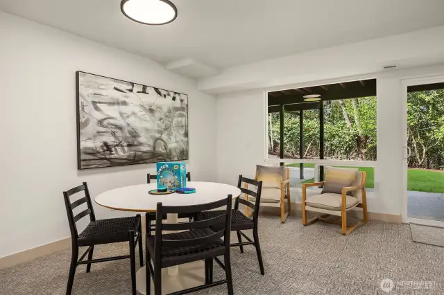 The family room—anchored by a second fireplace and glass sliders—leads to a patio and a fenced, private grassy yard, creating an ideal retreat for outdoor entertaining or quiet moments of calm.