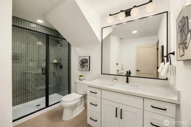 One of two stunning downstairs bathrooms, both newly added or reconfigured to maximize space and flow.