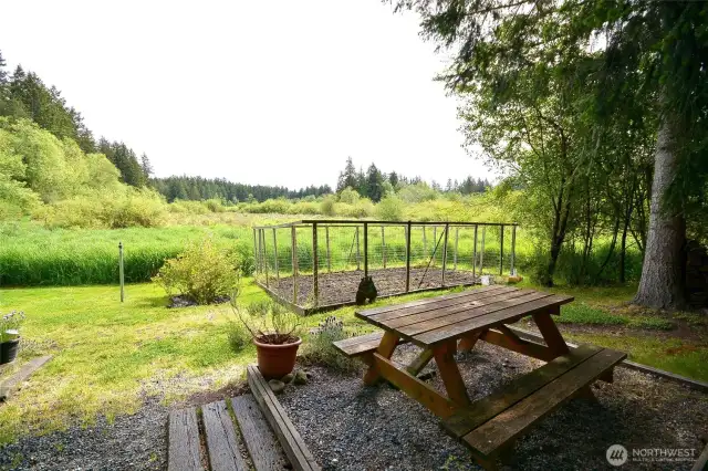 Picnic area with fire pit fenced garden area.