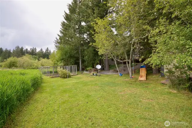 huge level area for playing, relaxing as you gaze into the meadow. This home is surrounded by nature, no homes can be built in the back or to the right of the property.