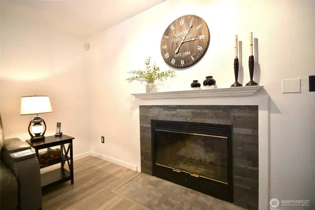 This beautiful Wood fireplace has tile surround and white wood mantel cozy up  on those chilly winter nights winter.