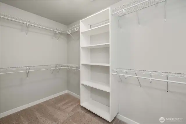 Primary walk-in closet with custom shelving