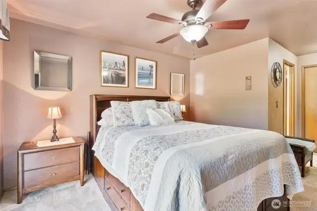Spacious primary bedroom with ceiling fan to keep you cool in the summer months!