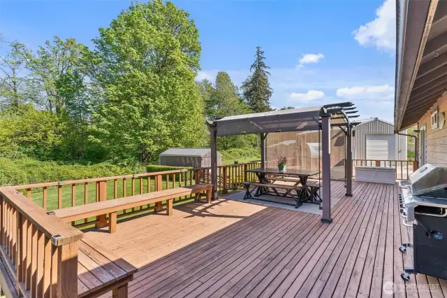 Enjoy the Spring on this deck with built in seating and pergola that stays with the home.