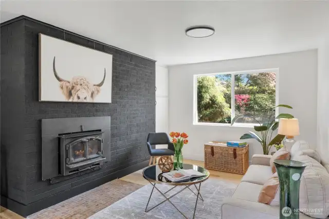 Functional woodburning stove gives the family room a cozy vibe and can heat the entire home, providing heat and cooking security for windy winter storm power outages!