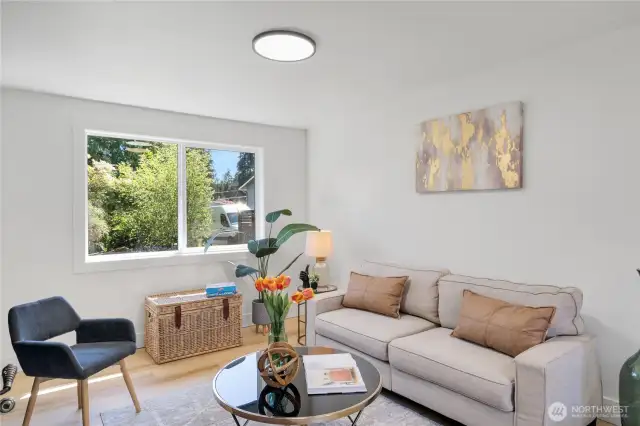 The bonus room has natural light from both sides with a generously sized window and a large slider leading to the backyard.