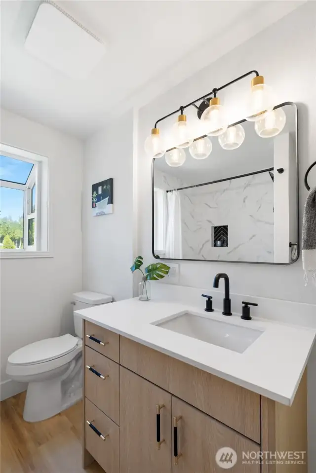 Main Bath, fully remodeled with a modern look and high quality finishes.