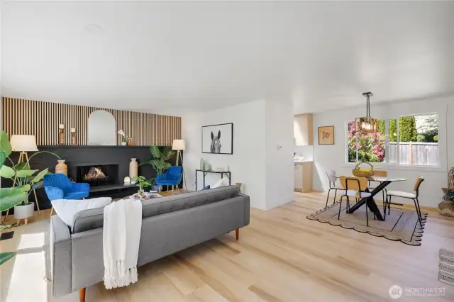 Enter into the spacious living and dining room, with ample natural light and an eye catching accent wall that includes a functional wood burning fireplace.
