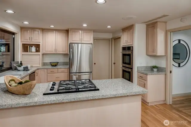 Elegant granite countertops, an undermount sink, and ample cabinetry make meal preparation effortless.