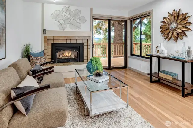 The space opens directly into a cozy family room, where a gas fireplace adds warmth and charm.