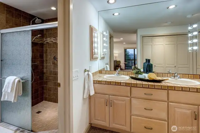 The en-suite bath features double vanity sinks and a large shower.