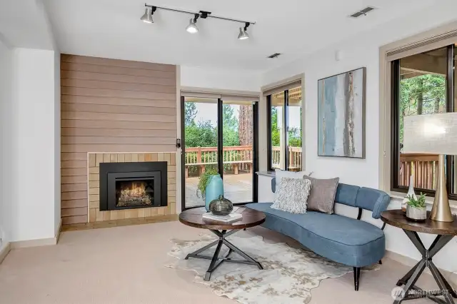 A gas fireplace and a comfortable sitting area make this a cozy spot to relax. Sliding glass doors open onto another deck, extending the indoor-outdoor living experience and offering another perfect place to soak in the natural surroundings.