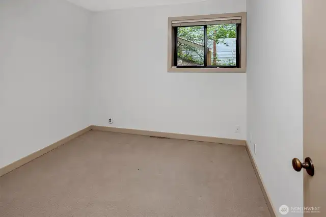 One of two additional spacious bedrooms and a full bathroom on this level provide plenty of room for guests or family members. Whether used for additional sleeping quarters, a home gym, or a creative studio, these rooms add flexibility to the home’s layout.