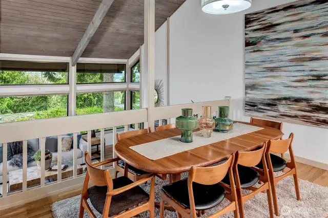 The dining area is both spacious and inviting, positioned to overlook the stunning living space.