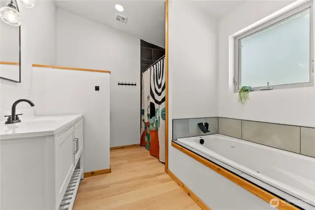 Soaking tub in ensuite bathroom off of primary bedroom.
